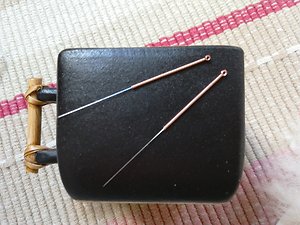 About Acupuncture. needles on a black cup